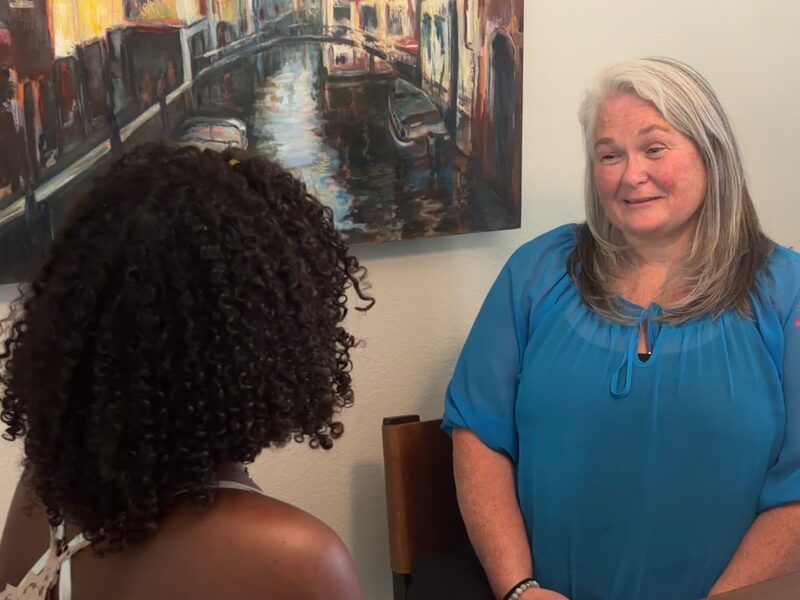 Jennifer Roy talking with a client during a therapy session