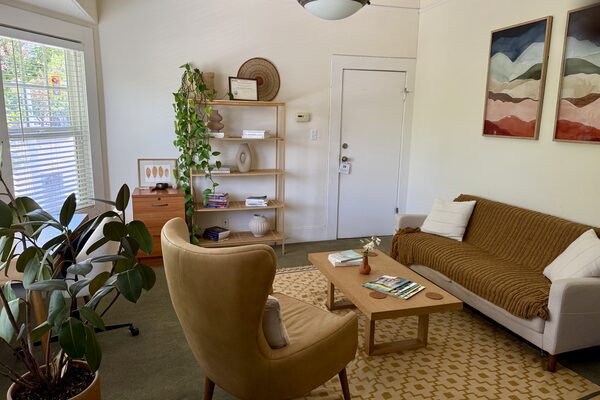 The San Rafael office seating area, with a sofa, armchair, and artwork